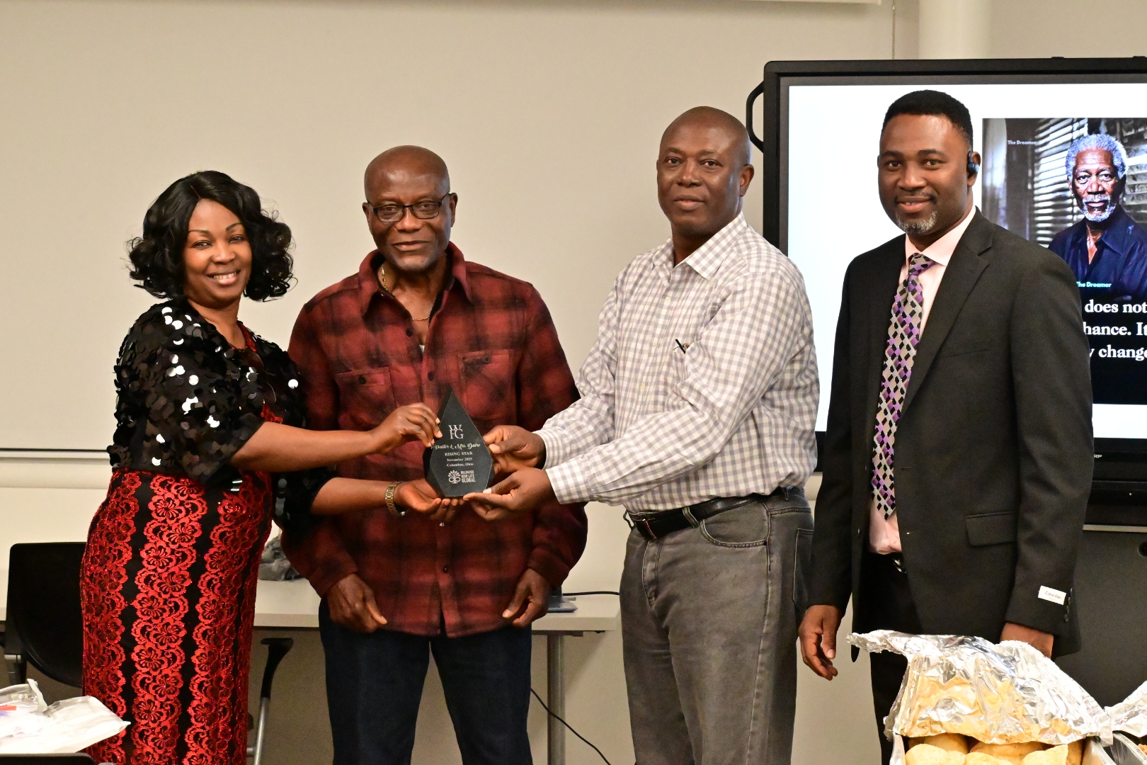 Isaac Oladeji ina an event with team